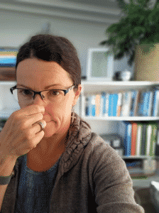 Nicky pinches both nostrils to do the Pause Control breathing test.